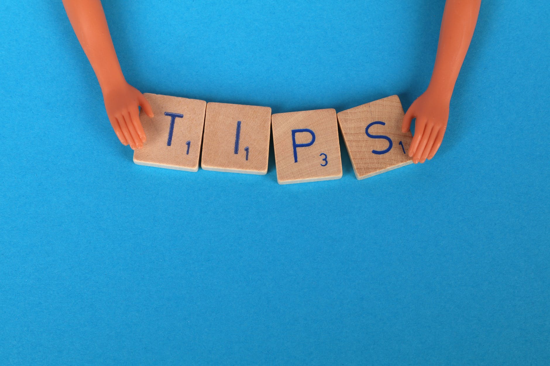 close up shot of scrabble tiles on a blue surface